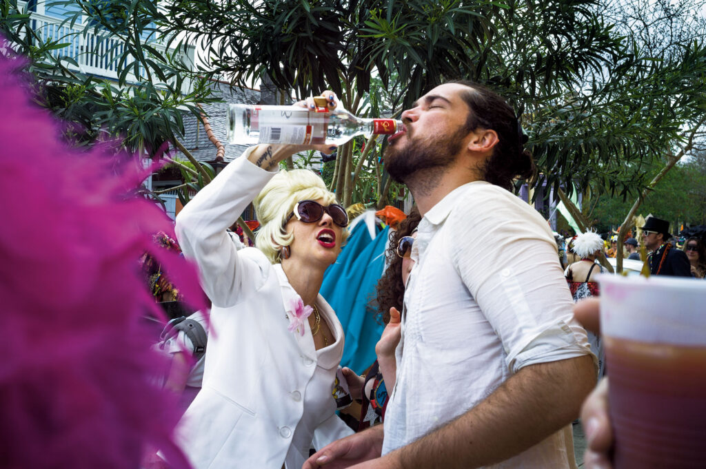 Retro diva awards a vodka shot to a stranger on Mardi Gras day, Marigny Triangle, 2017